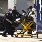 Stabbing victim wheeled into ambulance